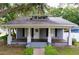 Charming single-story home featuring a welcoming front porch and beautiful, mature landscaping at 606 N Merrin St, Plant City, FL 33563