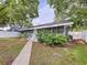 Charming home featuring a walkway leading to the front entrance and mature landscaping at 606 N Merrin St, Plant City, FL 33563