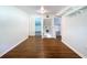 Hallway with hardwood floors and white walls leads to various rooms at 606 N Merrin St, Plant City, FL 33563