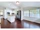 Open floor plan with kitchen, hardwood floors, and ample natural light at 606 N Merrin St, Plant City, FL 33563