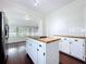 Kitchen island cooktop and dining area boast hardwood floors and natural light at 606 N Merrin St, Plant City, FL 33563