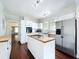 Bright kitchen features a center island with cooktop, stainless steel refrigerator, and butcher block countertops at 606 N Merrin St, Plant City, FL 33563