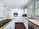 Bright white kitchen features butcher block countertops and stainless steel appliances at 606 N Merrin St, Plant City, FL 33563