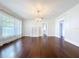 Bright living room featuring hardwood floors, white brick fireplace, and ample natural light at 606 N Merrin St, Plant City, FL 33563