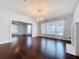 Beautiful living room boasts hardwood floors, stylish lighting, and an inviting layout to the next room at 606 N Merrin St, Plant City, FL 33563