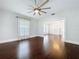 Inviting living room with rich hardwood floors, white trim, and an open doorway to the next room at 606 N Merrin St, Plant City, FL 33563