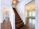 Staircase with hardwood steps and white trim at 606 N Merrin St, Plant City, FL 33563