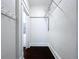 Walk-in closet with dark floors and wire shelving for organization and storage at 606 N Merrin St, Plant City, FL 33563
