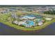 Aerial view of community amenities: clubhouse, pools, tennis courts, and playground at 6331 Voyagers Pl, Apollo Beach, FL 33572