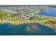 Aerial view of neighborhood with lakes, playground, walking paths, and green spaces at 6331 Voyagers Pl, Apollo Beach, FL 33572