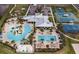 Aerial view of community amenities: pools, clubhouse, parking, sport courts and playground at 6331 Voyagers Pl, Apollo Beach, FL 33572