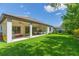 Spacious backyard with covered patio and lush green lawn perfect for entertaining at 6331 Voyagers Pl, Apollo Beach, FL 33572