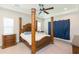 Bedroom with four-poster bed, tray ceiling, and neutral color scheme at 6331 Voyagers Pl, Apollo Beach, FL 33572