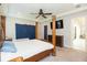 Light and airy bedroom features a four poster bed and ensuite access at 6331 Voyagers Pl, Apollo Beach, FL 33572