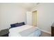 Minimalist bedroom with neutral tones, a comfortable bed, and ample closet space at 6331 Voyagers Pl, Apollo Beach, FL 33572