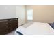 Cozy bedroom featuring a dresser, closet, window and a comfortable bed with star quilt at 6331 Voyagers Pl, Apollo Beach, FL 33572