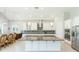 Modern kitchen with white cabinetry, stainless steel appliances, granite countertops, and a large center island at 6331 Voyagers Pl, Apollo Beach, FL 33572