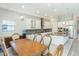 Open kitchen and dining area featuring pendant lighting, stainless steel appliances, and tile flooring at 6331 Voyagers Pl, Apollo Beach, FL 33572