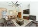 Inviting living room with a large sectional sofa, fireplace, and direct view into the dining and kitchen areas at 6331 Voyagers Pl, Apollo Beach, FL 33572