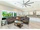 Open-concept living space features modern decor, a ceiling fan, and seamless flow to the kitchen and dining areas at 6331 Voyagers Pl, Apollo Beach, FL 33572