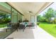 Inviting covered patio with comfortable seating and views of the landscaped backyard at 6331 Voyagers Pl, Apollo Beach, FL 33572