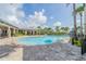 Community swimming pool features a unique design, pool rules sign, and brick paver decking at 6331 Voyagers Pl, Apollo Beach, FL 33572