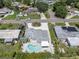 Aerial view of home and pool with beautifully landscaped yard and circular driveway at 6511 10Th N St, St Petersburg, FL 33702