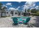 Stunning backyard featuring a pristine pool area with chairs and lush landscaping at 6511 10Th N St, St Petersburg, FL 33702