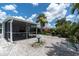 Lush backyard with a screened patio area, and beautiful landscaping creating a serene outdoor space at 6511 10Th N St, St Petersburg, FL 33702