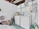 Functional basement laundry area with washer, dryer, and utility connections against white walls at 6511 10Th N St, St Petersburg, FL 33702