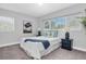 Cozy bedroom with beach-themed decor, large window, and soft lighting at 6511 10Th N St, St Petersburg, FL 33702