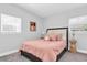 Comfortable bedroom with soft pink bedding, decorative accent table, and ample light at 6511 10Th N St, St Petersburg, FL 33702