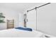 Bedroom featuring a sliding barn door, cozy decor, and a soft blanket at 6511 10Th N St, St Petersburg, FL 33702