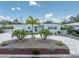 Beautiful single-story home featuring a circular driveway, palm trees, and a freshly landscaped front yard at 6511 10Th N St, St Petersburg, FL 33702