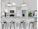 Stylish kitchen featuring white cabinets, stainless steel appliances, granite countertops, and barstools at 6511 10Th N St, St Petersburg, FL 33702