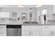 Bright kitchen with stainless steel appliances, granite countertops, and white cabinetry at 6511 10Th N St, St Petersburg, FL 33702