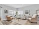 Serene living room with neutral decor, wood-look floors, and comfortable seating arrangements at 6511 10Th N St, St Petersburg, FL 33702