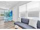 Cozy living room with a daybed, bright window, and decorative privacy screen at 6511 10Th N St, St Petersburg, FL 33702