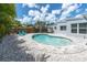 Serene backyard oasis featuring a custom-shaped pool, patio area, and well-maintained landscaping at 6511 10Th N St, St Petersburg, FL 33702