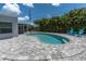 Charming pool area with stylish patio, lush greenery, and plenty of space for outdoor enjoyment at 6511 10Th N St, St Petersburg, FL 33702