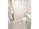 Modern bathroom showcasing tiled walls, a walk-in shower, and contemporary fixtures at 7684 Oakhurst Rd, Seminole, FL 33776