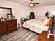 Inviting bedroom featuring two dressers, a fan, and a comfortable looking bed at 7684 Oakhurst Rd, Seminole, FL 33776