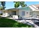 Side view of a one-story home with a patio, and mature trees providing shade at 7684 Oakhurst Rd, Seminole, FL 33776