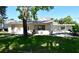 Inviting single-story home with covered patio and mature trees, offering charm and curb appeal at 7684 Oakhurst Rd, Seminole, FL 33776