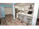 Modern kitchen features a large island with seating and opens to the adjacent areas of the home at 7684 Oakhurst Rd, Seminole, FL 33776