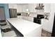 Modern kitchen offers stainless appliances, island with seating, and stylish white cabinetry for a sleek design at 7684 Oakhurst Rd, Seminole, FL 33776