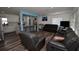 Modern living room with hardwood floors seamlessly connects to the open kitchen area, perfect for entertaining at 7684 Oakhurst Rd, Seminole, FL 33776