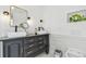 Stylish bathroom with a black vanity, double sinks, gold fixtures, and a decorative wall niche at 9329 Wellstone Dr, Land O Lakes, FL 34638