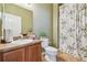 Bathroom with wooden vanity, framed mirror, and a shower with patterned curtain at 9329 Wellstone Dr, Land O Lakes, FL 34638