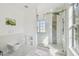 Bright bathroom showcasing a large glass enclosed shower with gold hardware, and a floating toilet at 9329 Wellstone Dr, Land O Lakes, FL 34638